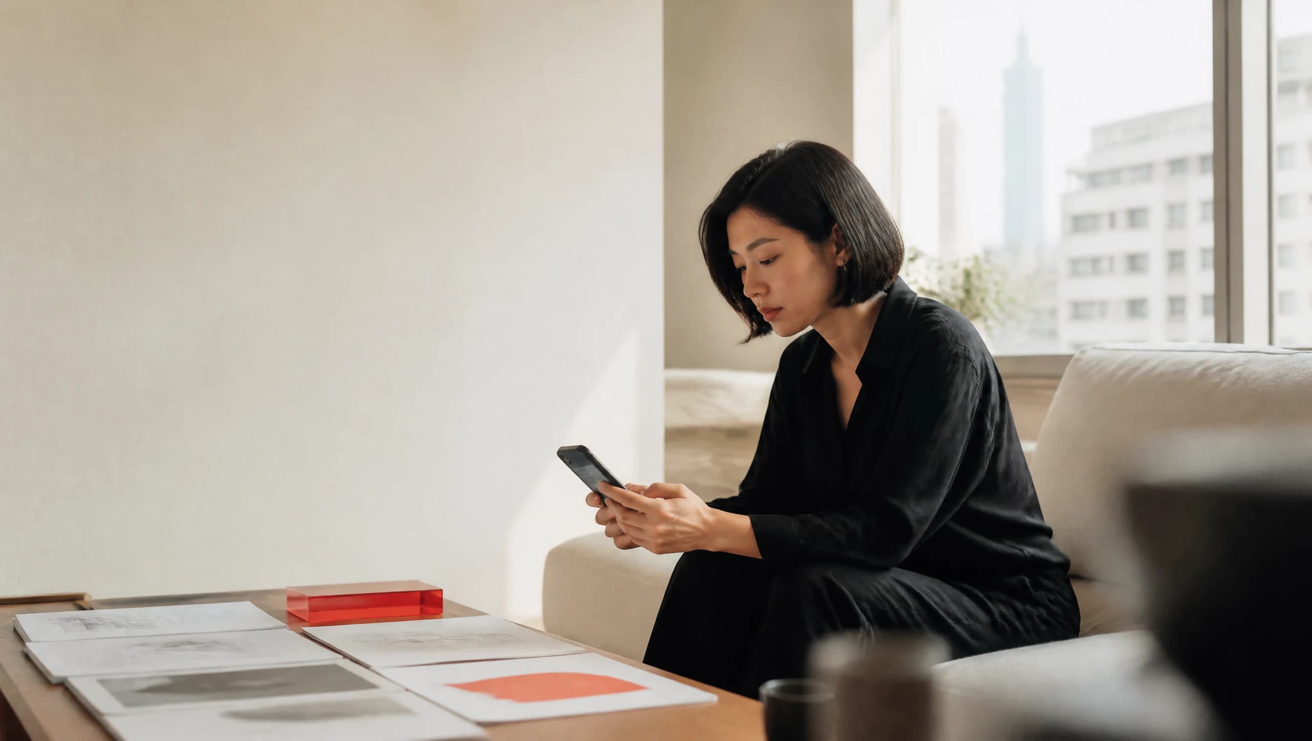 A creative director reviews a brand experience from a bright Taipei apartment