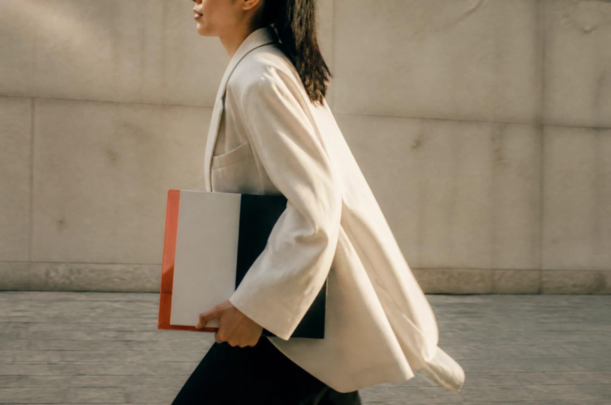 A moving figure carries a red, black and ivory campaign object through the city